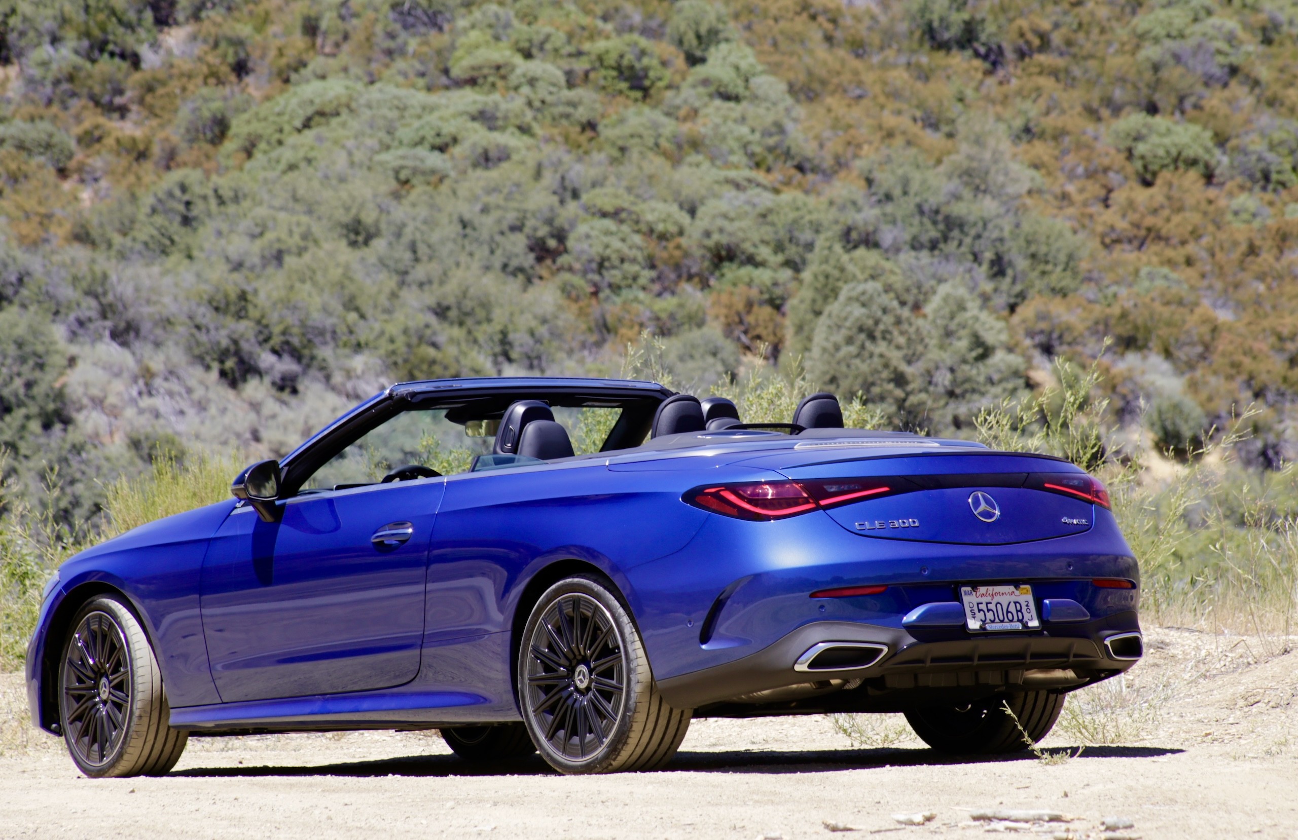 Angled front view of the 2024 Mercedes-Benz CLE300 Cabriolet highlighting its sleek headlights and sporty front bumper.