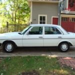 Classic Mercedes 240D parked outdoors, showcasing its timeless design