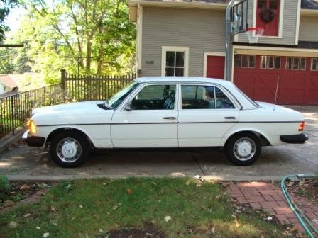 Classic Mercedes 240D parked outdoors, showcasing its timeless design