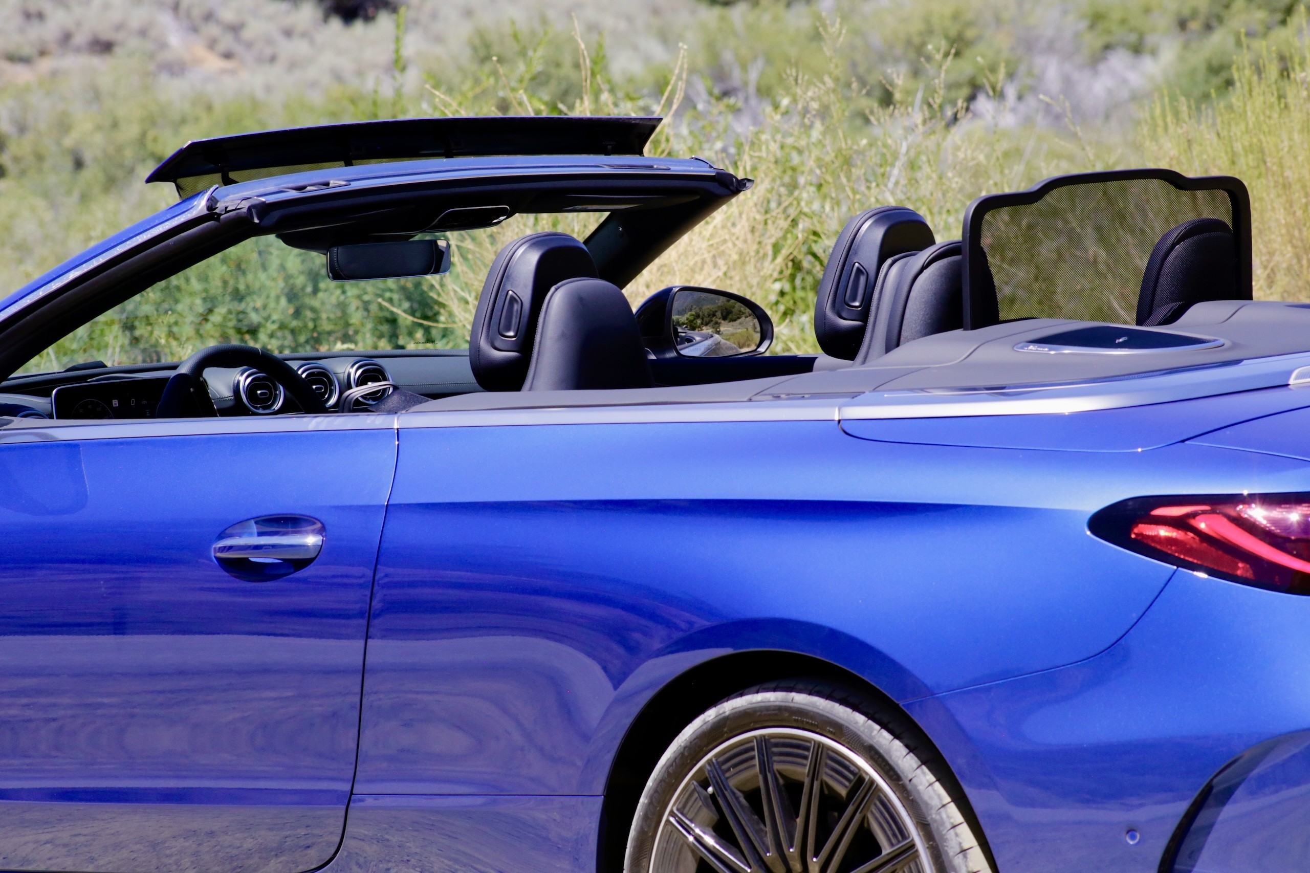 Close-up of the Mercedes-Benz Aircap system deployed on the 2024 Mercedes-Benz CLE300 Cabriolet, illustrating its wind deflection capability.