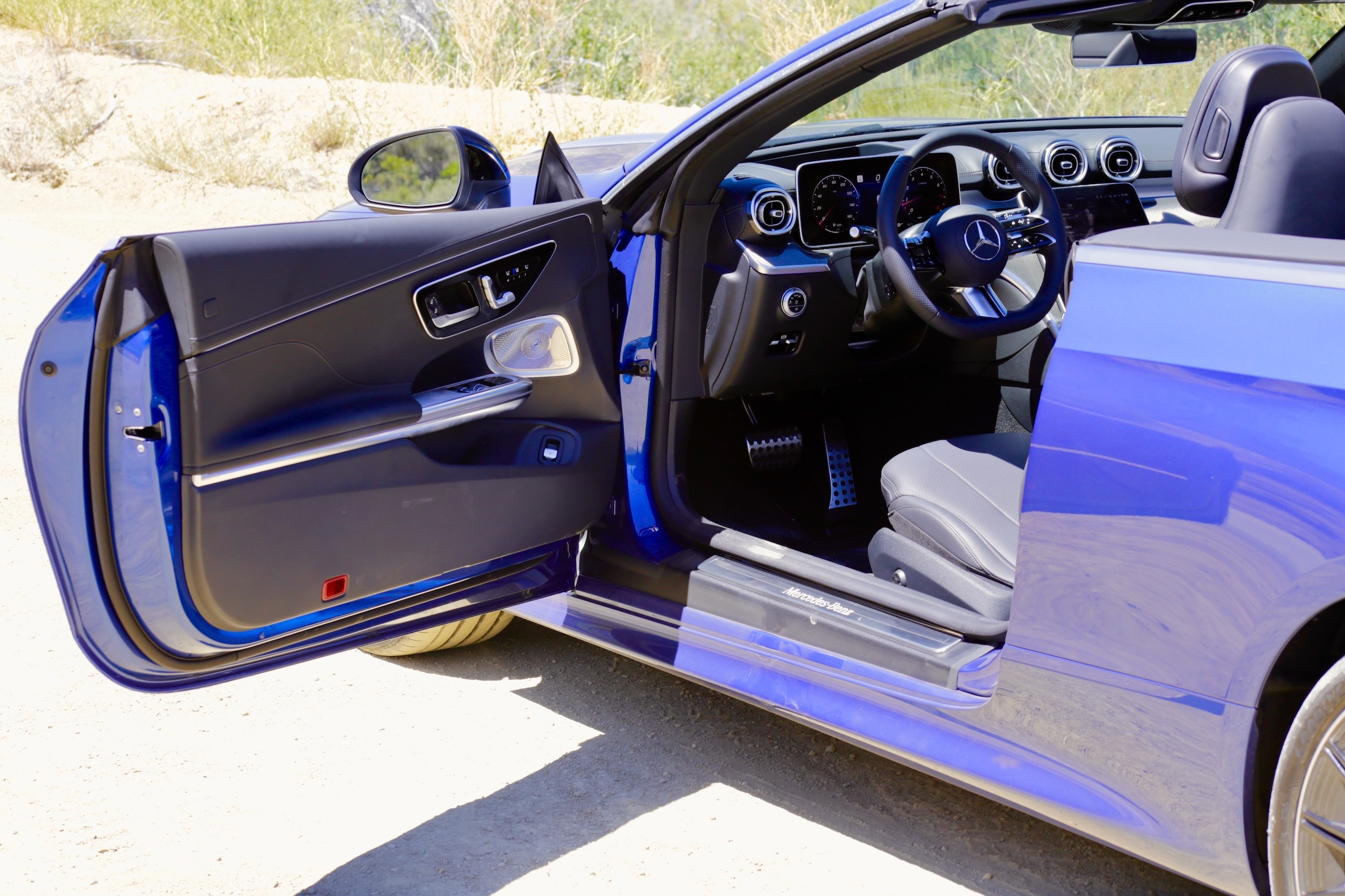 Detailed view of the 2024 Mercedes-Benz CLE300 Cabriolet interior, showcasing the door panel with leather trim and controls.