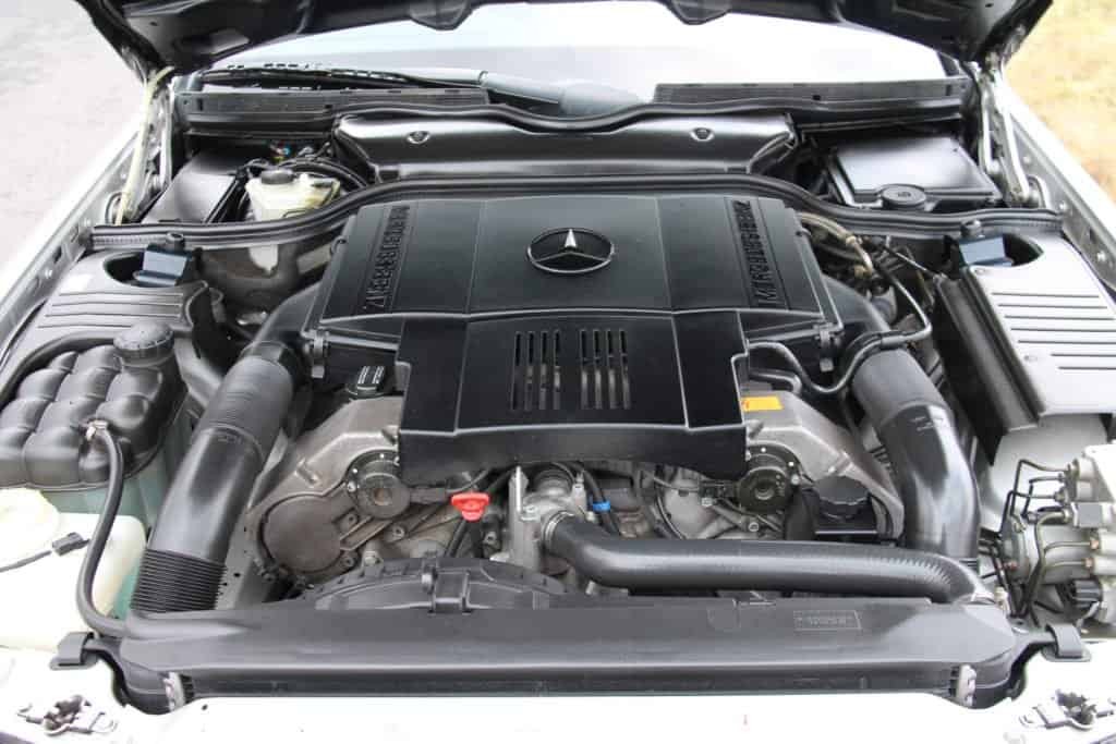 Early Mercedes-Benz R129 SL engine bay showcasing the M119 5.0-liter V8 engine, a powerful option from the initial release.