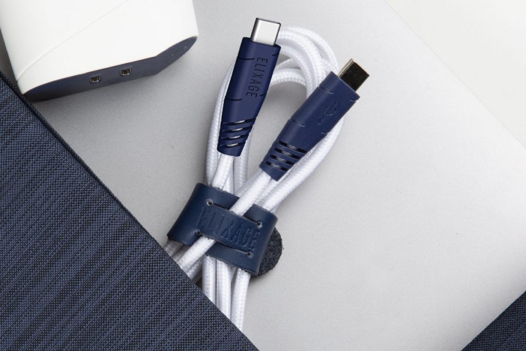 Elixage USB-C to Lightning and USB-C to USB-C braided cables in white and blue, organized with leather straps, representing durable and certified charging solutions.