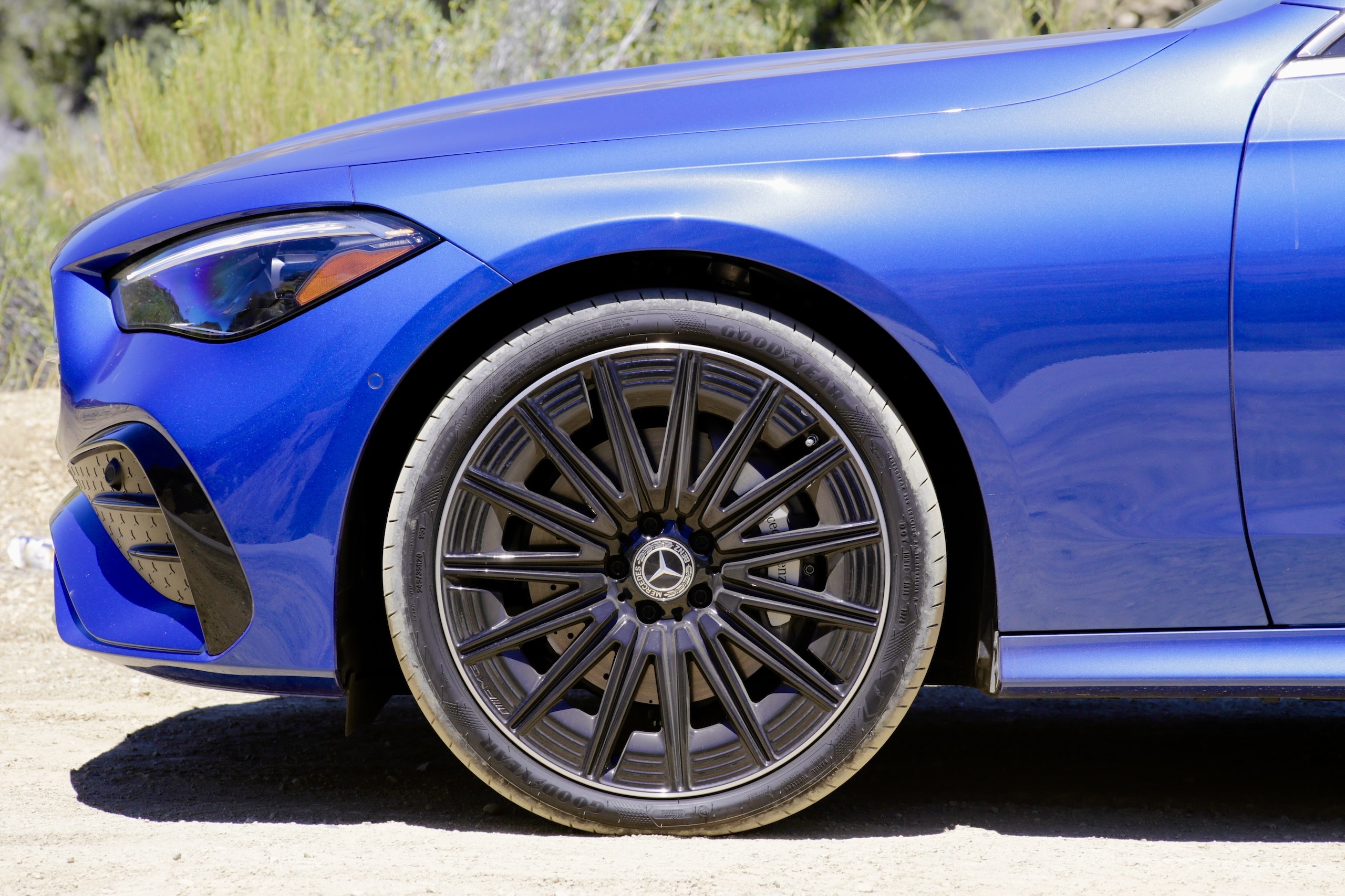 Front three quarter view of the 2024 Mercedes-Benz CLE300 Cabriolet braking, highlighting the AMG sport brakes.