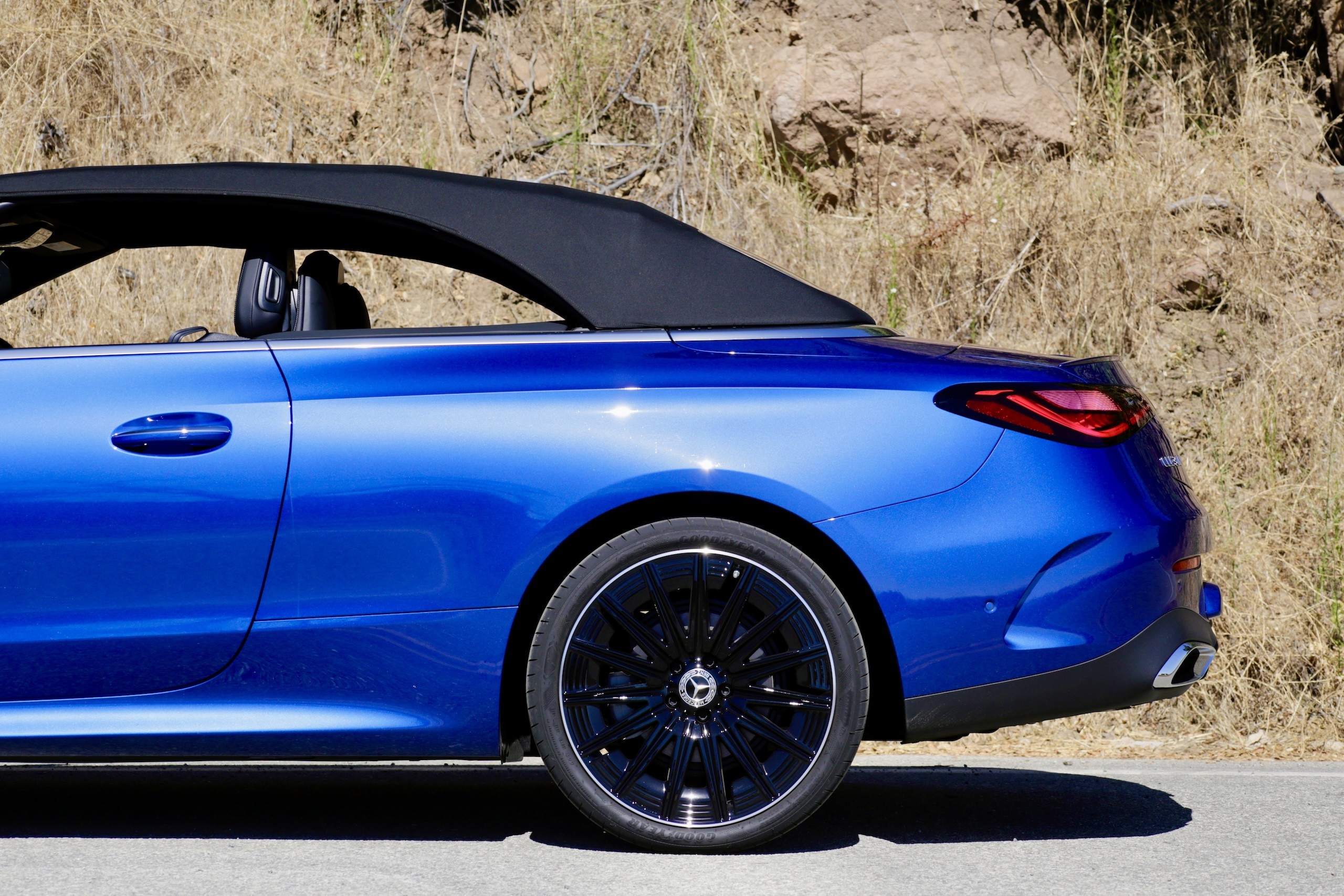 Front three quarter view of the 2024 Mercedes-Benz CLE300 Cabriolet parked in an urban setting, showcasing its city-friendly size.