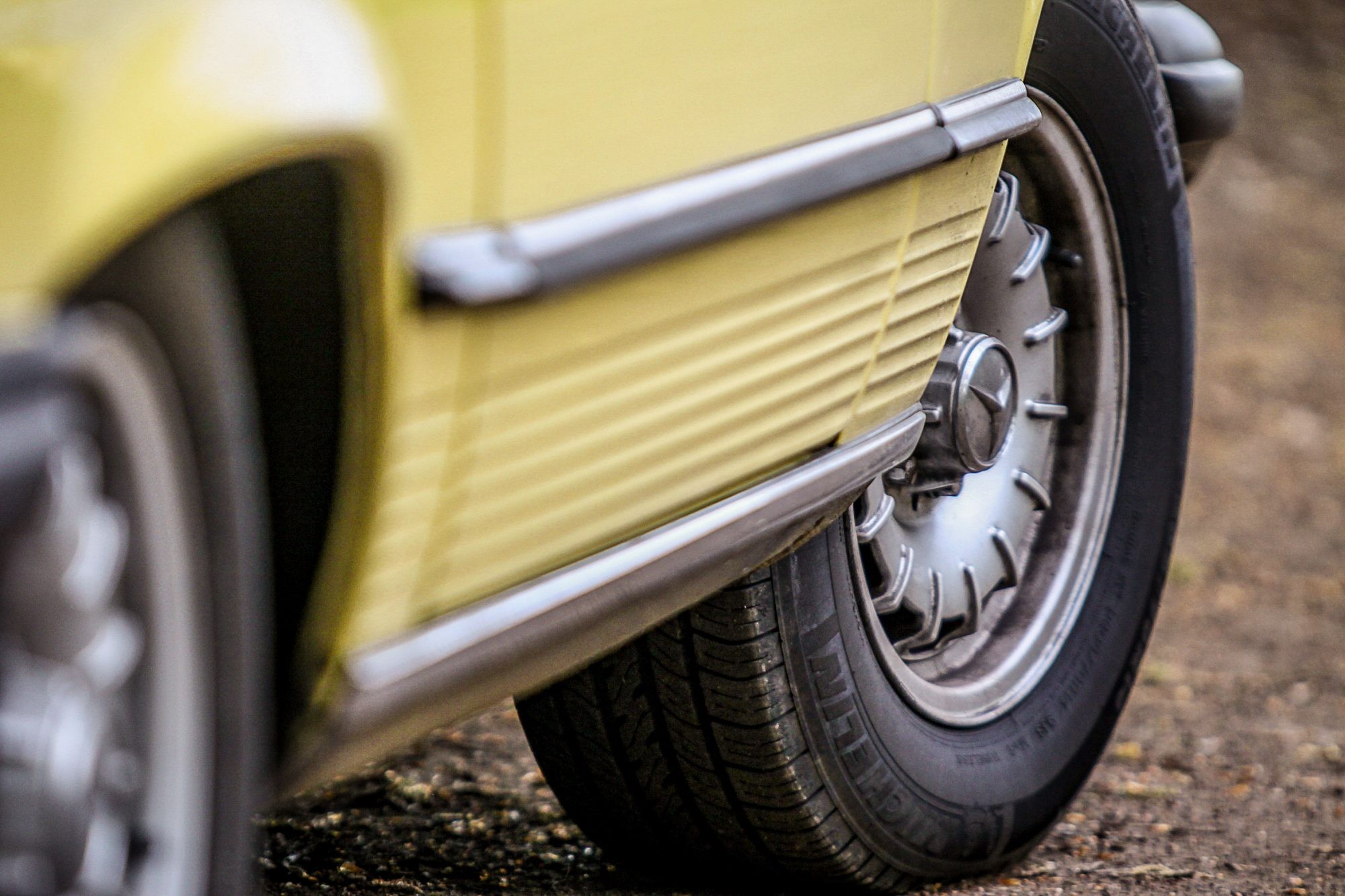 Iconic yellow Mercedes-Benz R107 from the Hart to Hart TV series, showcasing its classic design.