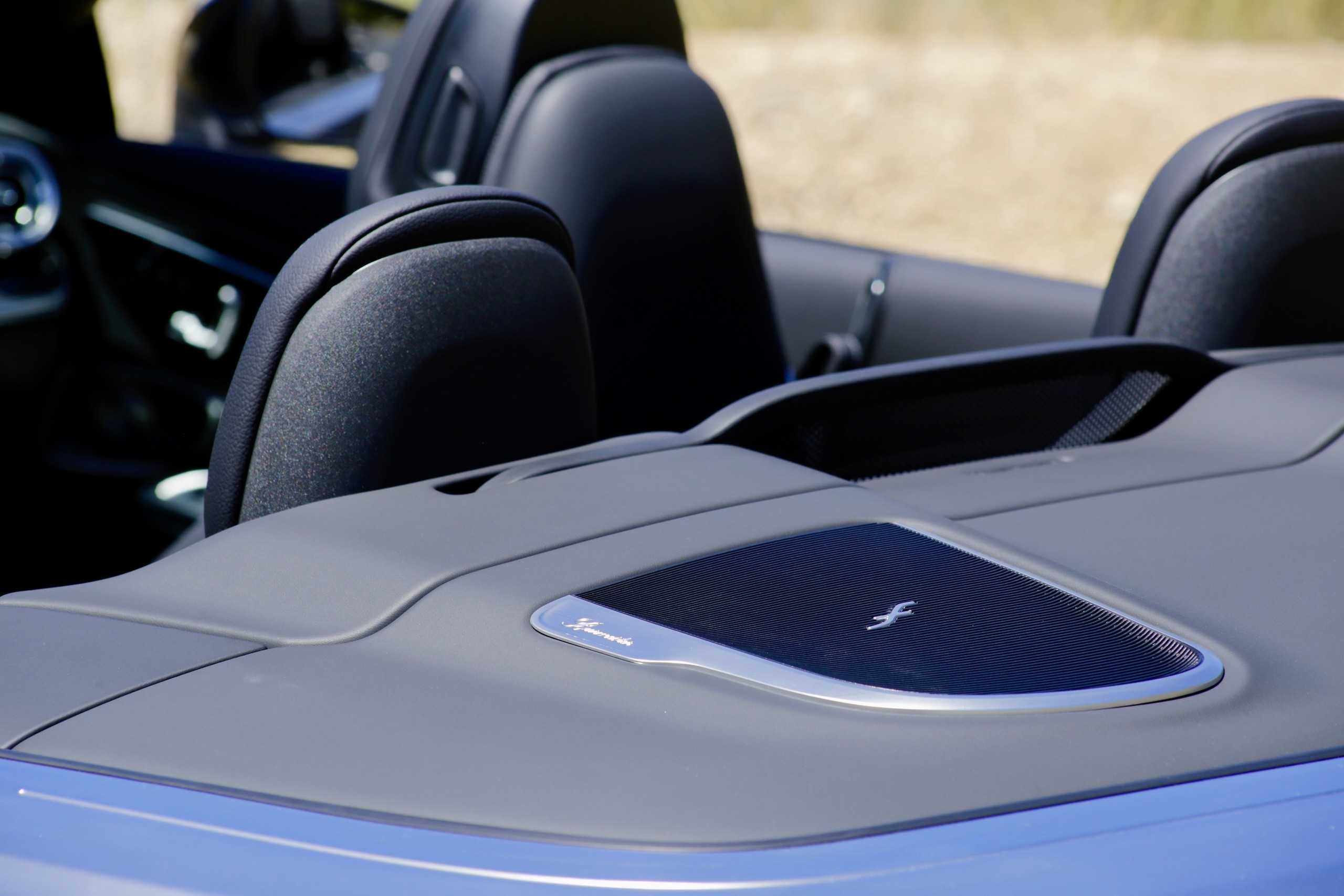 Interior detail of the 2024 Mercedes-Benz CLE300 Cabriolet showing the Burmester sound system speaker and ambient lighting.