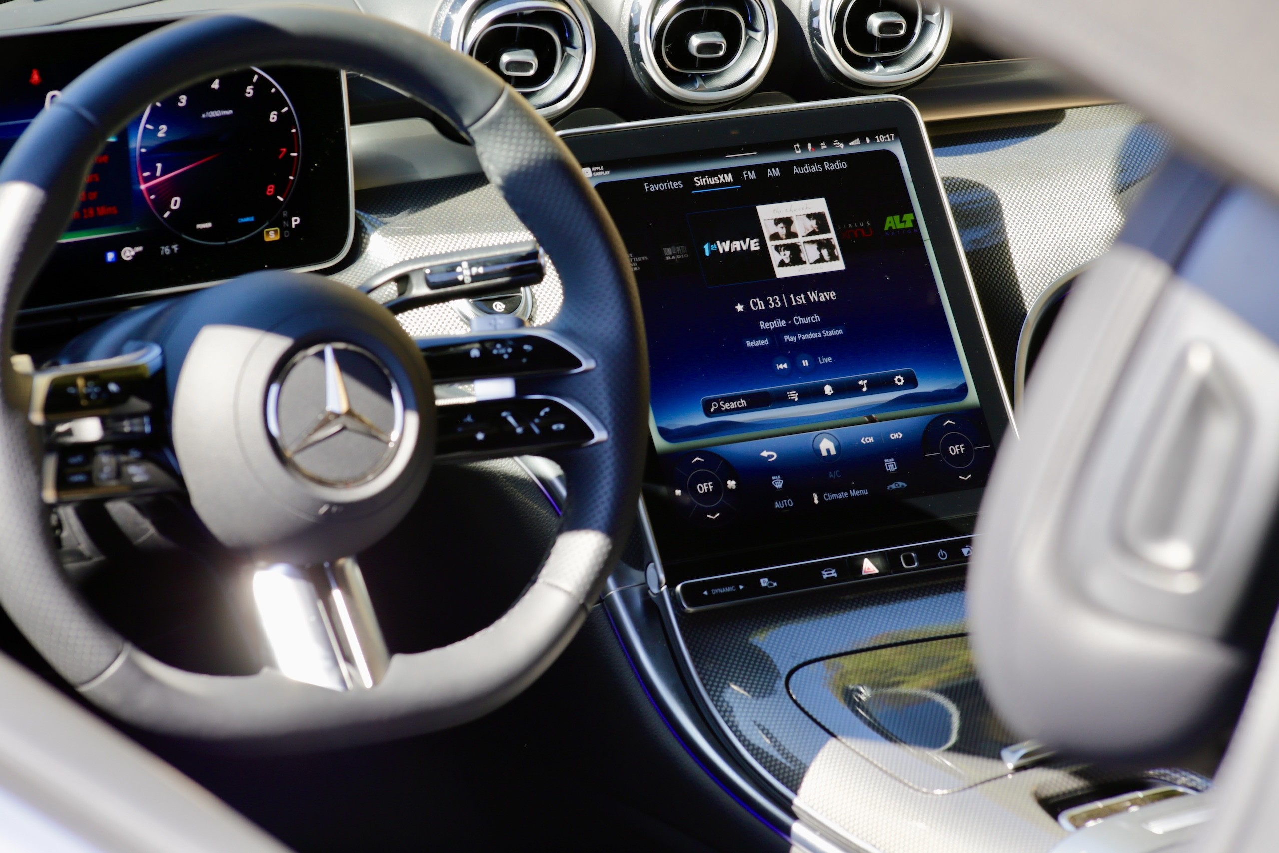 Interior shot of the 2024 Mercedes-Benz CLE300 Cabriolet dashboard and center console, emphasizing the minimalist design and large screens.