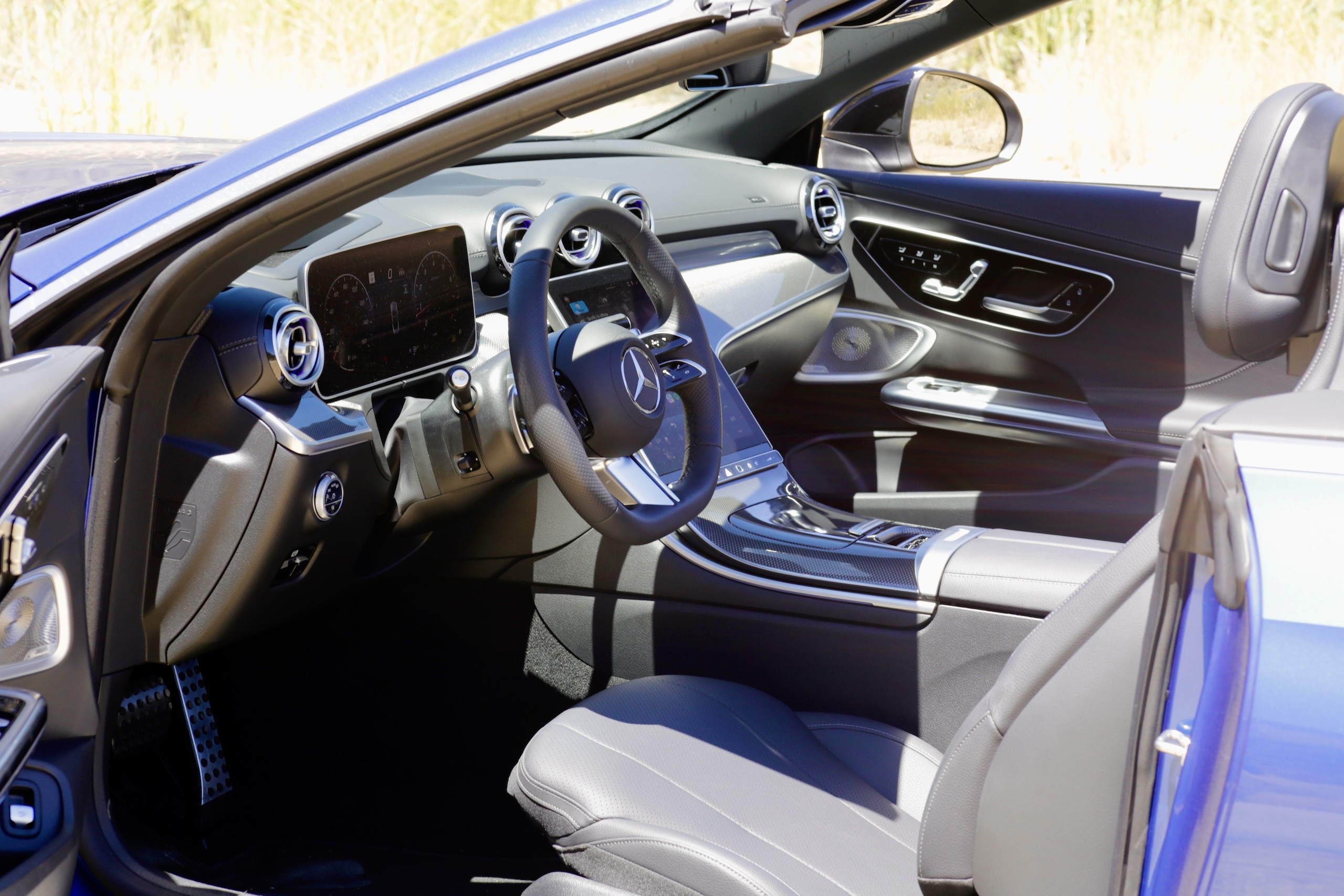 Interior view of the 2024 Mercedes-Benz CLE300 Cabriolet cockpit, showing the digital instrument cluster and central touchscreen display.