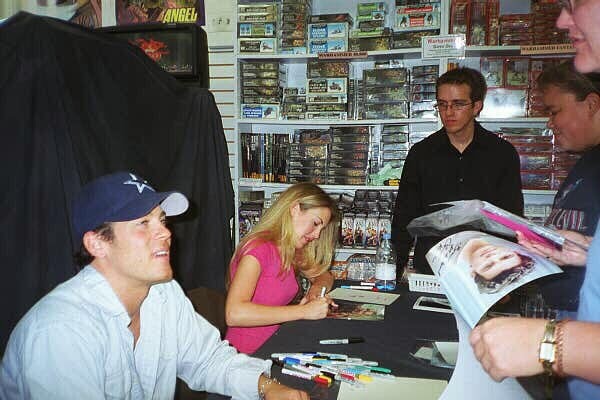 Mercedes McNab at an autograph session, showcasing her friendly demeanor and connection with fans, highlighting her role in popular tv shows.