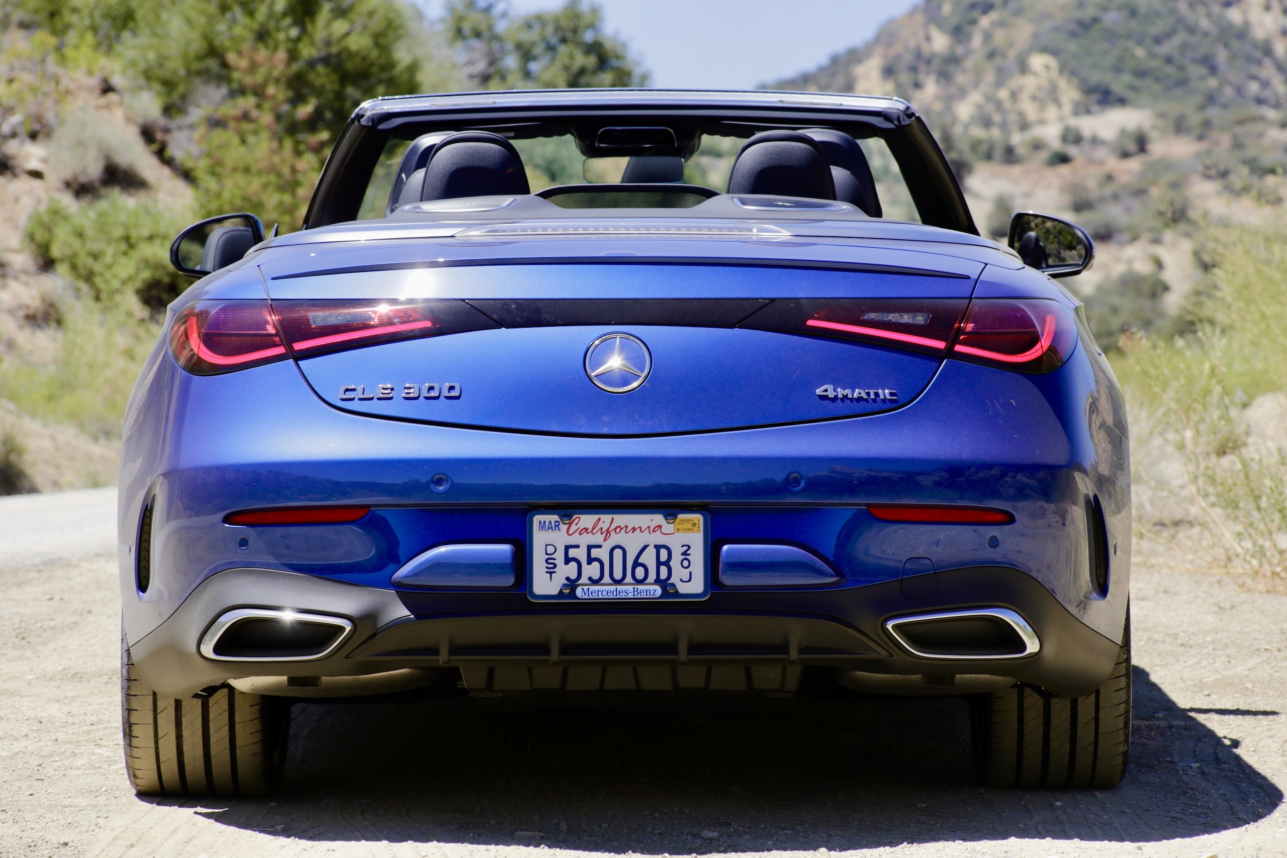 Rear angled shot of the 2024 Mercedes-Benz CLE300 Cabriolet emphasizing its modern taillights and subtle spoiler.