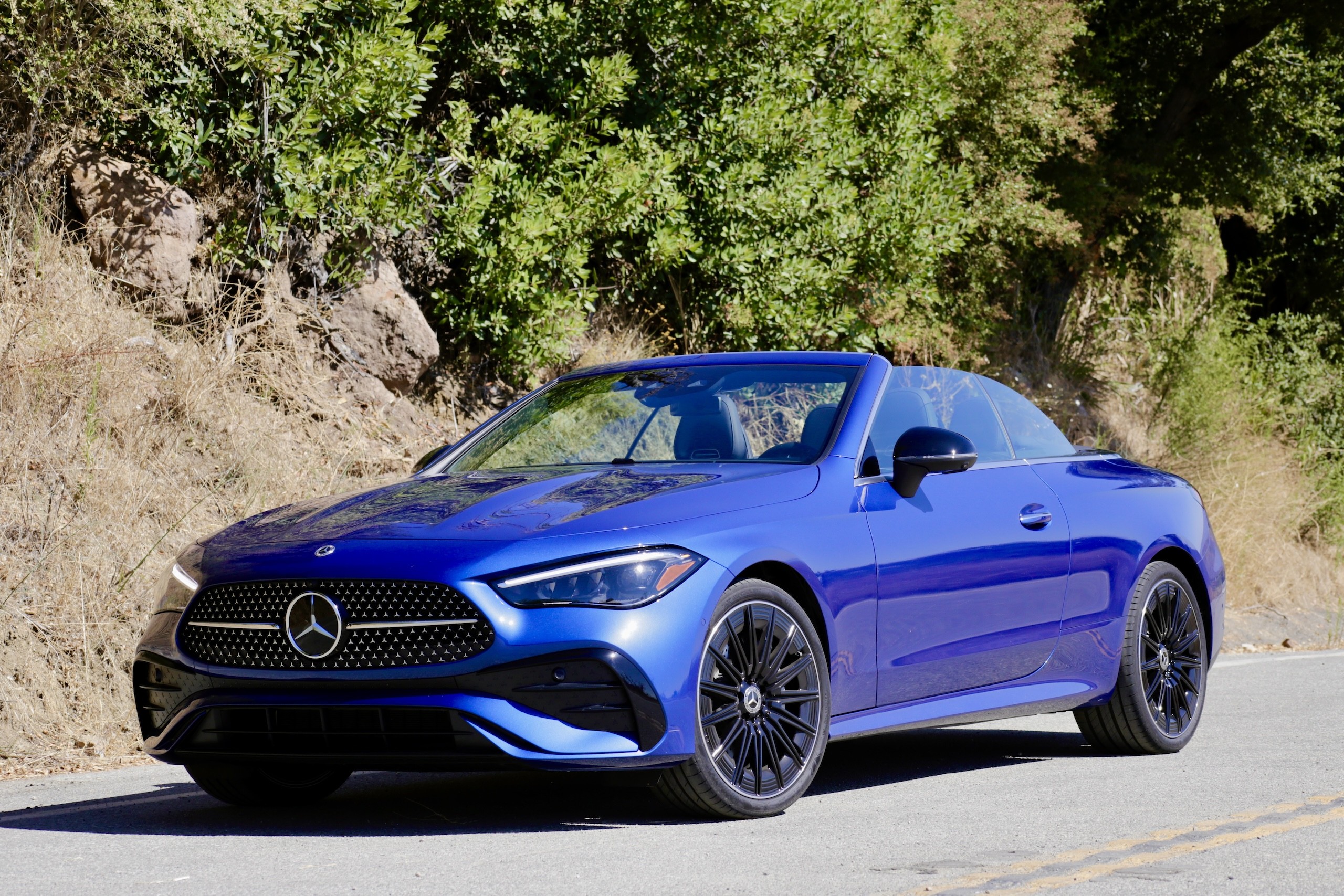 Various detail shots of the 2024 Mercedes-Benz CLE300 Cabriolet highlighting design elements like the wheels, Aircap system, and interior trim.