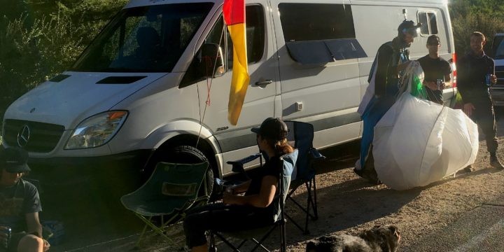 Two Sprinter vans, one with a Mercedes logo and the other with a Dodge logo, parked side-by-side illustrating the branding difference between the vehicles